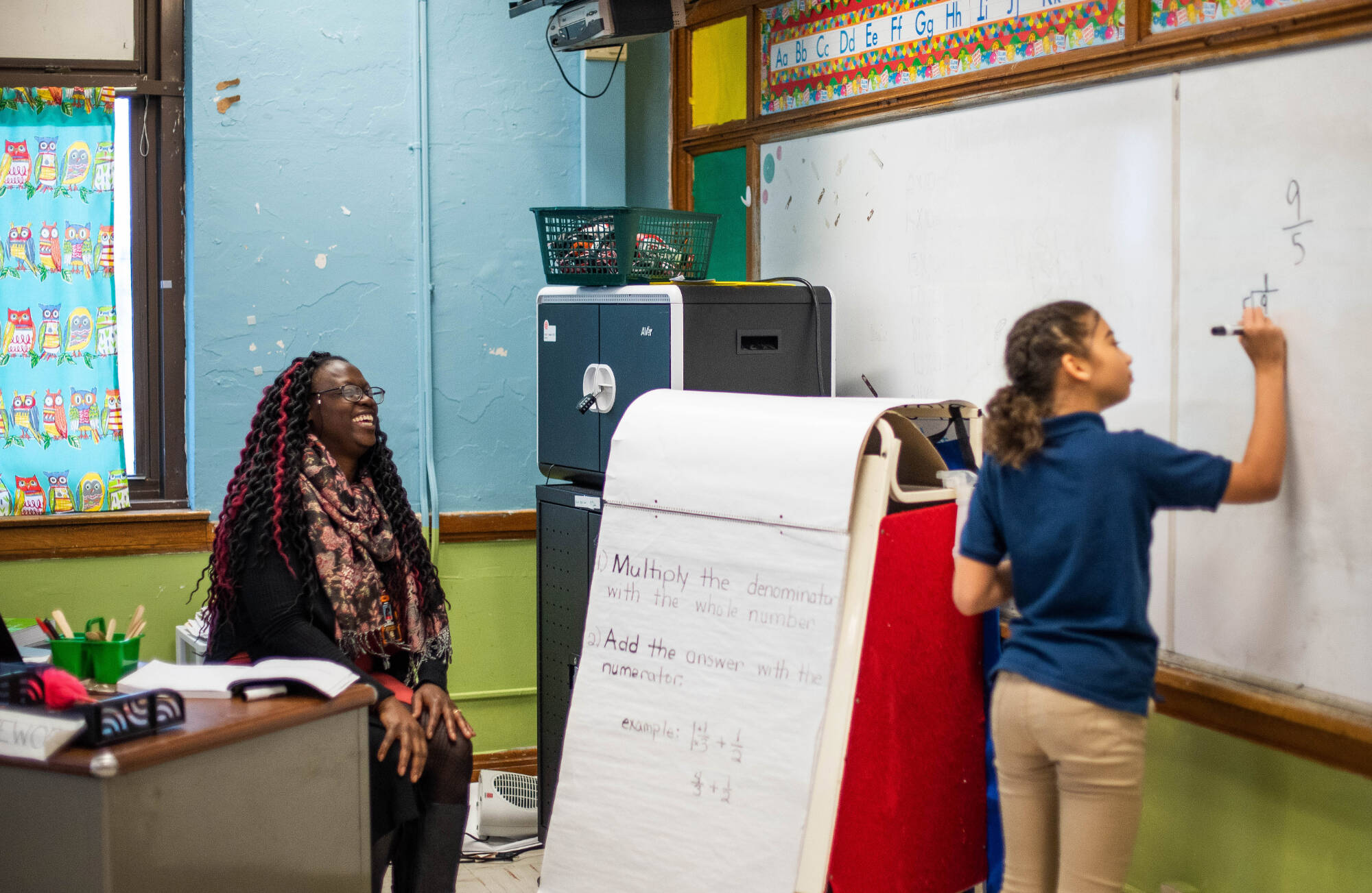 a teacher with students in a classroom